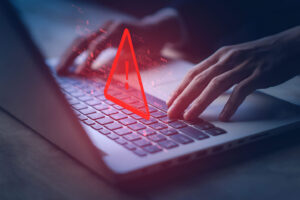 laptop and warning sign, cloning scams
