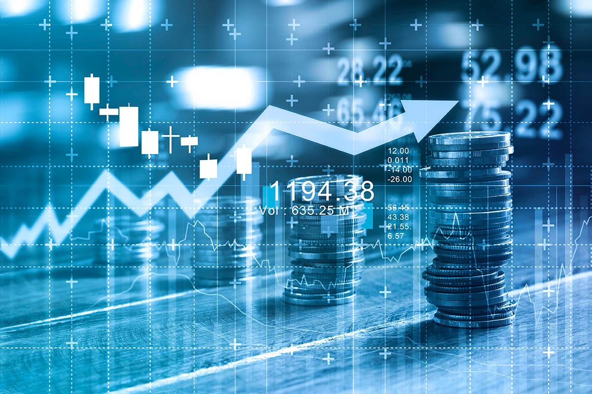Finance and business concept. Investment graph and rows growth and of coins on table, blue colour tone.