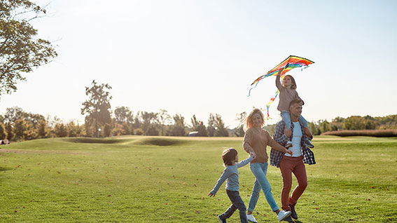 Family enjoying the park getting budget-ready this summer